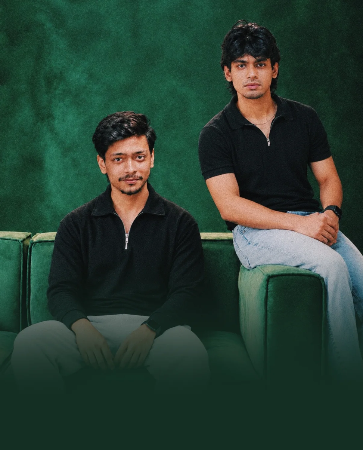 Azwah founders Rakib and Fahmid sitting on a green sofa